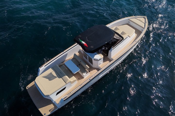 Aerial view of a modern motorboat on dark blue water.