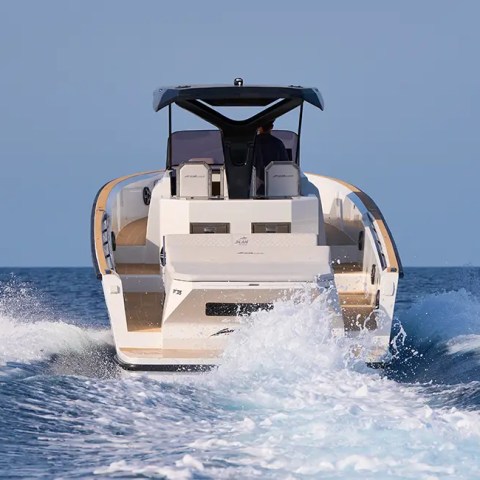 Motorboat speeding on open water, leaving a wake behind.